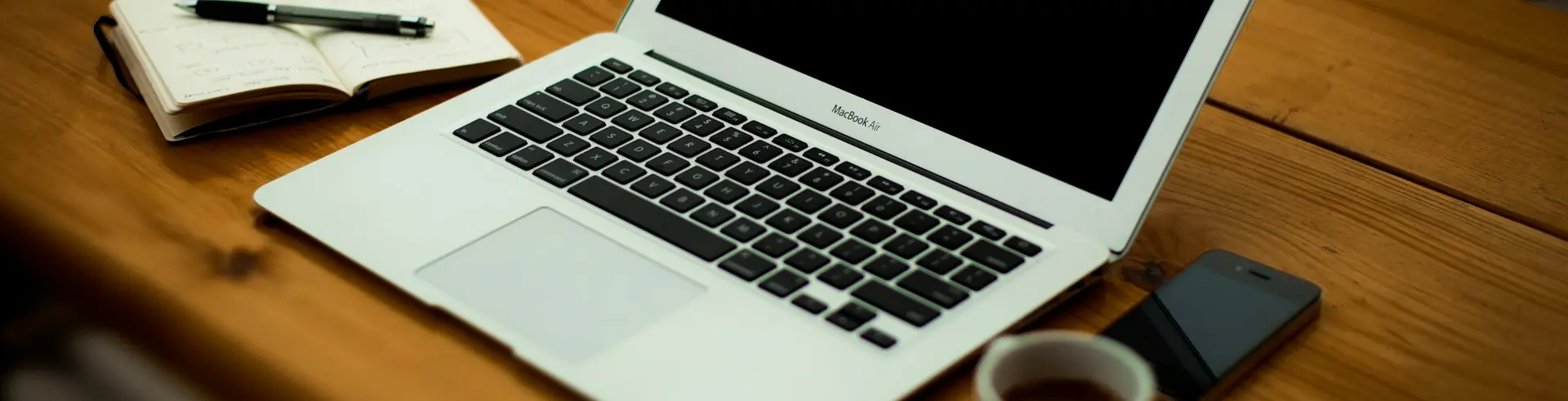 MacBook Air on brown wooden table